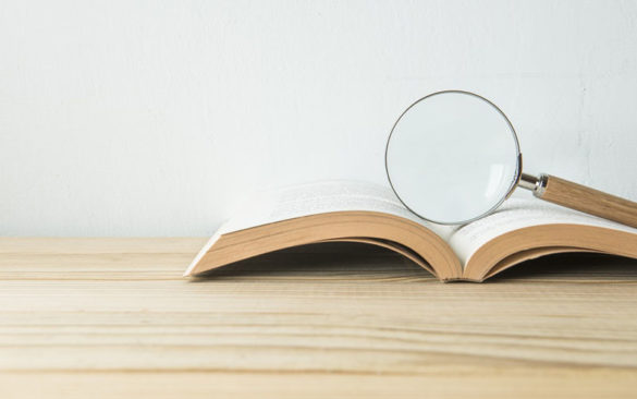 Magnifying glass on an open book